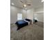 Comfortable bedroom with gray carpet, ceiling fan and a mirrored sliding door closet at 1327 Union St, Columbus, IN 47201