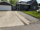Long driveway leading up to a detached garage. Gray siding on house at 1327 Union St, Columbus, IN 47201