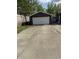 Detached garage with a large, white garage door and concrete driveway at 1327 Union St, Columbus, IN 47201