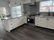 Modern kitchen features white cabinets, stainless steel appliances, and a gray backsplash, providing a sleek and contemporary design at 1327 Union St, Columbus, IN 47201
