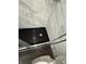 Modern shower with a marble surround, glass door, and sleek black fixtures at 1327 Union St, Columbus, IN 47201