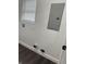 Functional utility room equipped with electrical panel, window, and laminate floors, designed for practical household needs at 1327 Union St, Columbus, IN 47201