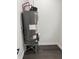 Hot water heater installed in a dedicated utility space with laminate flooring, ensuring reliable hot water supply at 1327 Union St, Columbus, IN 47201