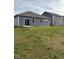 Backyard showcasing a well-maintained lawn and a view of the home's exterior with several windows at 1380 Fairmount Dr, Greenfield, IN 46140