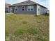 Backyard view of the home featuring a patio and sprawling green lawn at 1380 Fairmount Dr, Greenfield, IN 46140