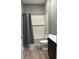 Full bathroom with gray walls, white subway tiles, and a shower-tub combo at 1380 Fairmount Dr, Greenfield, IN 46140