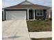 Charming single-story home with attached garage, well-kept lawn, and inviting front porch at 1380 Fairmount Dr, Greenfield, IN 46140