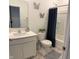 Clean bathroom featuring a modern vanity, stylish mirror, shower with curtain and decorative butterfly accents at 142 Winding Brook Way, Pendleton, IN 46064