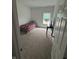 Bedroom features a single bed, window, and carpeted floors, offering a cozy retreat at 142 Winding Brook Way, Pendleton, IN 46064