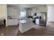 Bright eat-in kitchen features white cabinets, stainless steel appliances, and a spacious center island at 142 Winding Brook Way, Pendleton, IN 46064