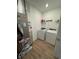 Clean laundry room with modern washer, dryer, and shelf at 142 Winding Brook Way, Pendleton, IN 46064