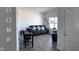 Bright living room featuring neutral walls, wood floors, a cozy seating area and a home office space at 142 Winding Brook Way, Pendleton, IN 46064