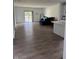 Open-concept living room with sleek wood floors, neutral walls, slider door and a cozy seating area at 142 Winding Brook Way, Pendleton, IN 46064