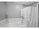 Bathroom featuring white soaking tub with white tile surround and a gray painted wall at 14634 Village Park East Dr, Carmel, IN 46033