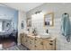 Bright bathroom featuring double sink vanity with decorative black and white tile floors and subway tile at 14634 Village Park East Dr, Carmel, IN 46033