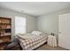 This bedroom offers natural light with gray walls, a bookcase, and hardwood floors at 14634 Village Park East Dr, Carmel, IN 46033