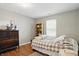 This bedroom boasts hardwood floors, a cozy rug, and a window for natural light at 14634 Village Park East Dr, Carmel, IN 46033