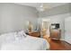 Bright bedroom featuring hardwood floors, neutral walls, and a peek into the bathroom at 14634 Village Park East Dr, Carmel, IN 46033