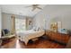 Cozy bedroom with wood floors, neutral colors, and a ceiling fan at 14634 Village Park East Dr, Carmel, IN 46033