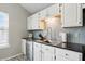 Kitchen area with stainless steel dishwasher, undermount sink and gray backsplash at 14634 Village Park East Dr, Carmel, IN 46033