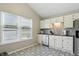 Bright kitchen with white cabinets, stainless steel appliances and decorative tile floors at 14634 Village Park East Dr, Carmel, IN 46033