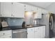 Kitchen featuring stainless steel appliances, sleek countertops, and ample white cabinetry at 14634 Village Park East Dr, Carmel, IN 46033