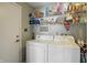 Practical laundry room with shelving and washer and dryer at 14634 Village Park East Dr, Carmel, IN 46033