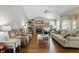 Spacious living room featuring hardwood floors, neutral paint, and ample seating at 14634 Village Park East Dr, Carmel, IN 46033