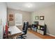 Home office features a large black desk chair and lots of sunlight at 14634 Village Park East Dr, Carmel, IN 46033