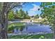 Scenic pond with a fountain, surrounded by lush landscaping and mature trees in a tranquil setting at 14634 Village Park East Dr, Carmel, IN 46033