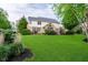 Expansive backyard with lush green lawn, landscaping, and patio area at 14707 Thor Run Dr, Fishers, IN 46040