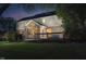 Backyard view at dusk featuring patio and deck illuminated by house lights at 14707 Thor Run Dr, Fishers, IN 46040