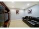 Finished basement with a large entertainment center and plush leather sofa at 14707 Thor Run Dr, Fishers, IN 46040