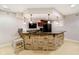 Basement bar featuring stone accents, pendant lighting, and seating, perfect for entertaining guests at 14707 Thor Run Dr, Fishers, IN 46040