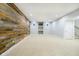 Spacious basement with neutral carpet, and a decorative wooden wall at 14707 Thor Run Dr, Fishers, IN 46040