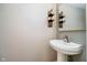Charming powder room featuring a pedestal sink and decorative wall accents at 14707 Thor Run Dr, Fishers, IN 46040