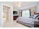Comfortable bedroom featuring neutral tones, soft textures, and a window for ample natural light at 14707 Thor Run Dr, Fishers, IN 46040