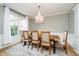 Elegant dining room featuring a chandelier, large window, and stylish furniture on an area rug at 14707 Thor Run Dr, Fishers, IN 46040