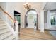 Bright foyer with high ceilings, an elegant chandelier, light wood flooring, and a staircase at 14707 Thor Run Dr, Fishers, IN 46040
