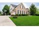 Beautiful home with a large front yard, brick facade, black shutters, an attached garage, and professional landscaping at 14707 Thor Run Dr, Fishers, IN 46040