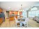 Open concept kitchen and dining area with wood cabinets, granite countertops, and stainless steel appliances at 14707 Thor Run Dr, Fishers, IN 46040