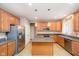 Spacious kitchen features wood cabinets, granite countertops, stainless steel appliances, and an island at 14707 Thor Run Dr, Fishers, IN 46040