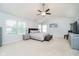 Bright main bedroom with vaulted ceilings, carpet floors, large windows and comfortable gray furnishings at 14707 Thor Run Dr, Fishers, IN 46040