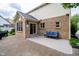 Inviting brick patio with comfortable blue sofa, perfect for outdoor relaxation at 14707 Thor Run Dr, Fishers, IN 46040