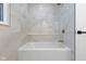 Bright bathroom with a soaker tub with gold hardware and white tile at 16 Maplecrest Dr, Carmel, IN 46033