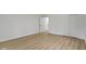 Bright bedroom with laminate flooring, neutral paint, closet with doors, and white trim at 16 Maplecrest Dr, Carmel, IN 46033