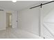 Bedroom featuring a sliding barn door and an open doorway at 16 Maplecrest Dr, Carmel, IN 46033