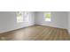 Empty bedroom with hardwood floors and a pair of windows to let in natural light at 16 Maplecrest Dr, Carmel, IN 46033