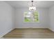 Dining room with hardwood floors, white walls, and decorative chandelier at 16 Maplecrest Dr, Carmel, IN 46033