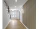 Bright entryway featuring hardwood floors, a decorative wall, and a staircase at 16 Maplecrest Dr, Carmel, IN 46033